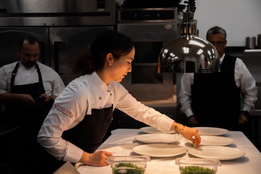 FILE: Sachi Statz, the chef behind the Miami-based Tínta y Café, plates a dish for an event.