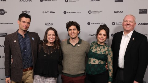 Five people stand side-by-side.