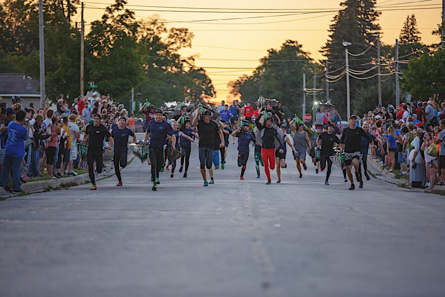 At 9:00 pm, the Sheriff fires his gun, signaling the mad dash to the river. The teams run with their canoes through the streets of Grayling, past thousands of frenzied fans, to the river to begin the 120-mile non-stop overnight race. The scene has been described as the most exciting four minutes in sports.