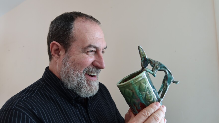 Troy Bungart and one of his whimsical rabbit mugs.