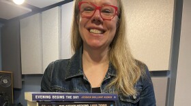Rachel Barenbaum with a stack of books by New England authors.