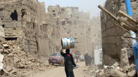 A Yemeni woman walks through a heavily damaged neighbourhood in the war-battered city of Saada, 240 kms (150 miles) north of the Yemeni capital Sanaa, on March 8, 2010, one month after a truce was declared between the Shiite rebels and government forces. Dammaj, in Saada province, is currently outside of effective Yemeni government control.