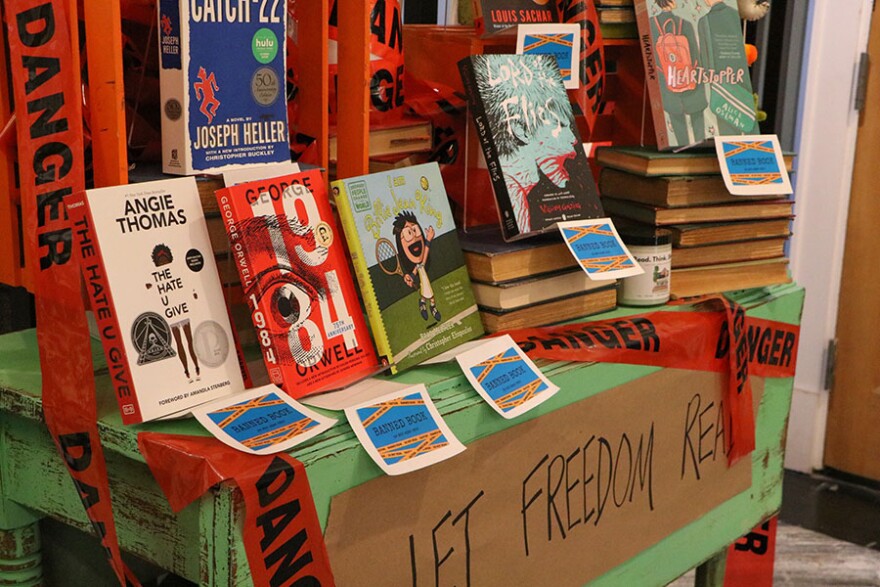  Banned book section at Midtown Reader with books like 'Heartstopper' by Alice Oseman and 'Lord of the Flies' by William Golding.