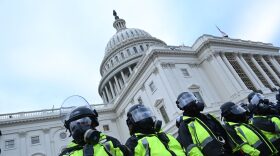 Police stand as supporters of US President Donald Trump protest outside the US Capitol in Washington, DC.