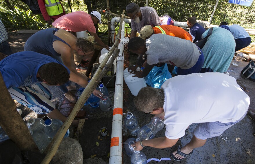 Residents fill containers with water in Cape Town, South Africa, on Feb. 1. Officials say the city could run out of water in April. It's just one of many challenges facing South Africa.