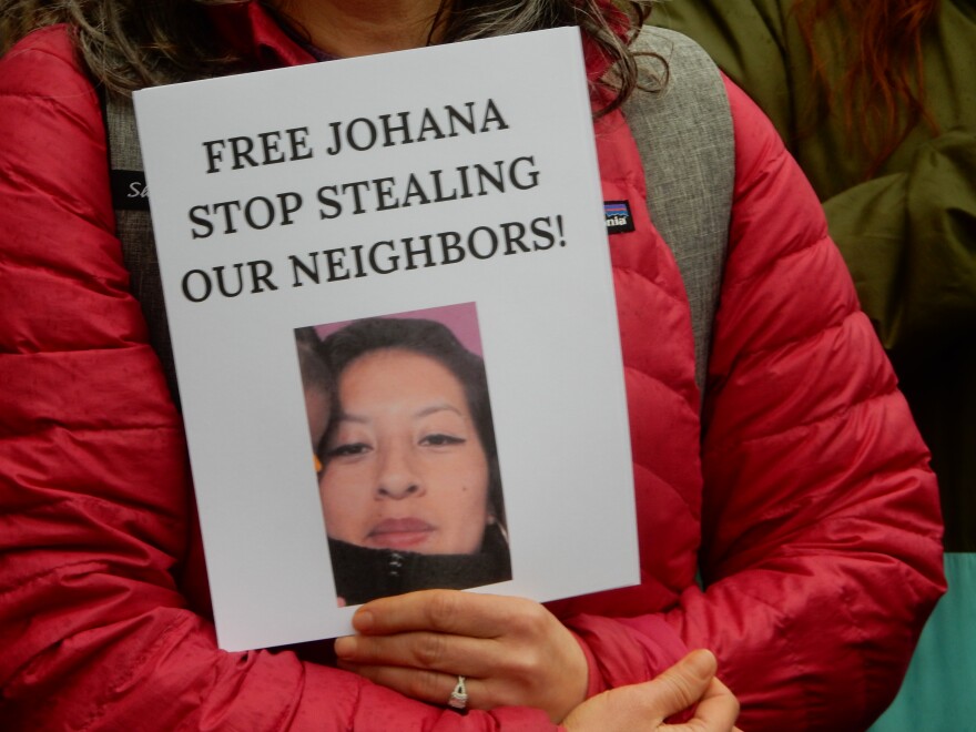 A person holds a sign during a Migrant Justice rally for detainees