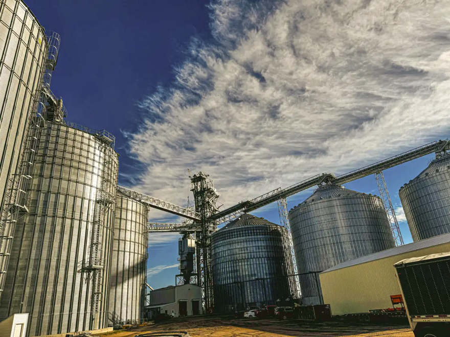 A series of grain storage bins tower over a CHS co-op in Warren, Minnesota. 
