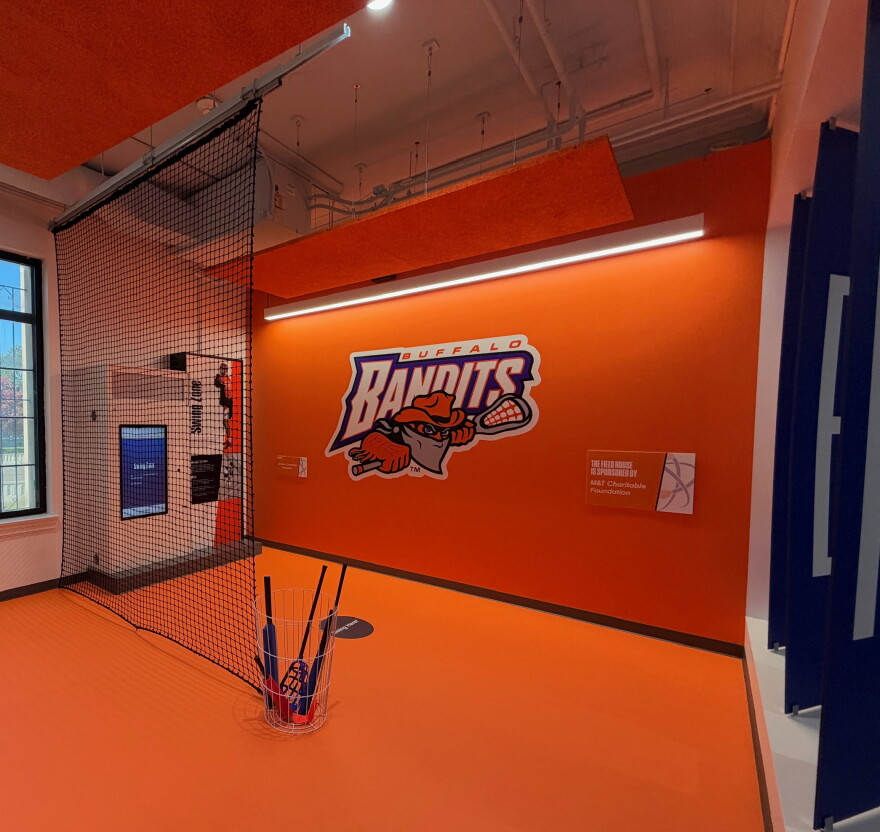 Bandits learn to swing a lacrosse stick station at the new sports exhibit