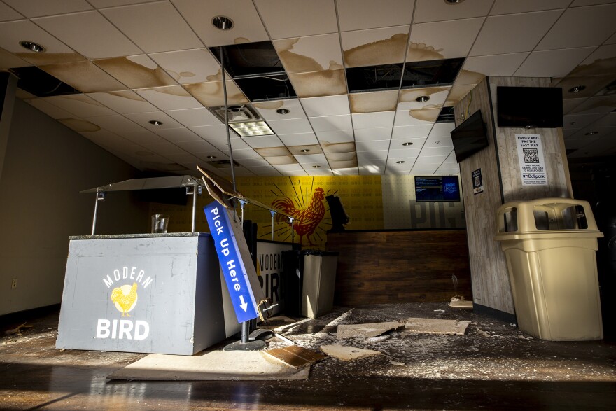 In interior room inside a stadium shows debris after hurricane damage