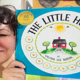 Sandra Cisneros holds up a copy of The Little House by Virginia Lee Burton.