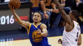 Golden State Warriors guard Stephen Curry (L) shoots over Cleveland Cavaliers guard J.R. Smith (R) during Game 6 of the NBA Finals in Cleveland, Ohio.