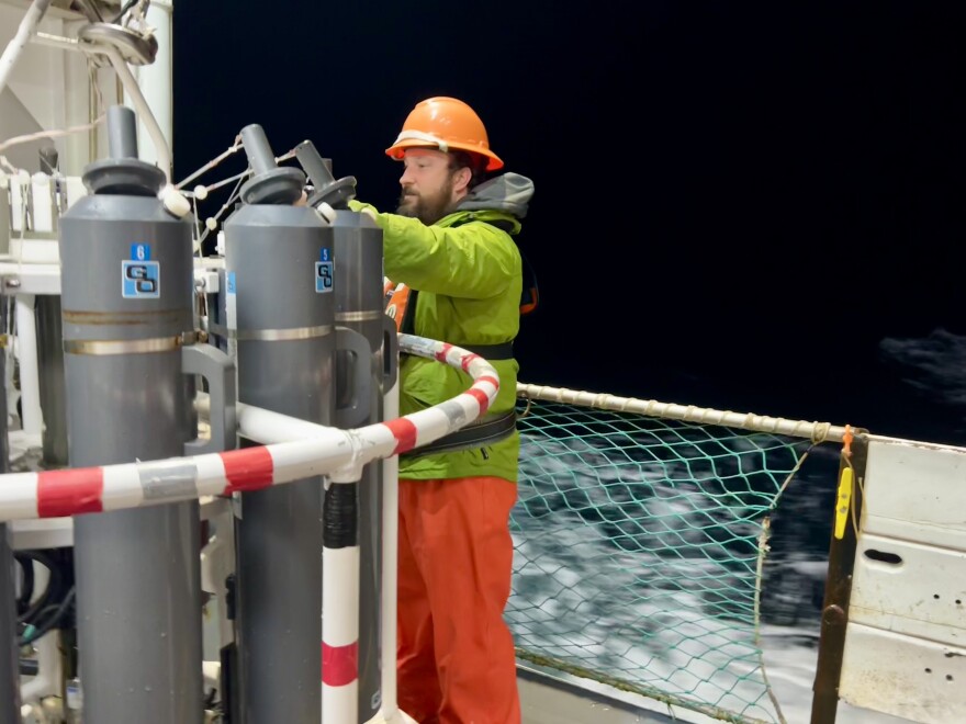  Jonathan Witmer, a survey technician with NOAA, readies equipment for the scientists as waves crash against the side of the ship.