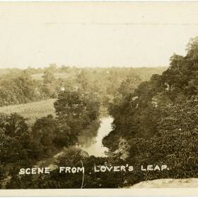 An old black and white picture of a cliffside view of Hinkson Creek, with the words "scene from Lover's Leap" written on the bottom.