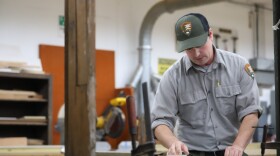Kent Cook, a historic preservationist for Cuyahoga Valley National Park, works in a maintenance garage in Brecksville on Aug. 28, 2025.