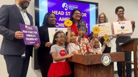 Congresswoman Tlaib and the speakers at Friday's press conference pose with children, holding signs supporting the Head Start program.