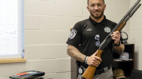 Kingfisher County Sheriff Aaron Pitts stands in his office with the gun initially labeled as missing in an audit by the State Auditor's Office.