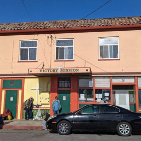 People gather outside the Victory Mission shelter on Soledad Street in Salinas, Calif. City leaders approved using more than $1.1 million in federal funds to potentially purchase the property as part of a Chinatown revitalization effort.