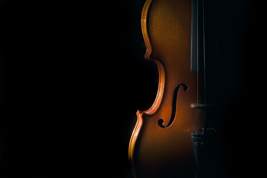 Violin on a black background with spot light.