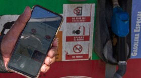 Retiree Jorge Reyes shows his phone with the app "El Ticket" which is used to reserve a place in line to buy rationed gasoline in Havana, Cuba, Monday, Feb. 16, 2026. (AP Photo/Ramon Espinosa)