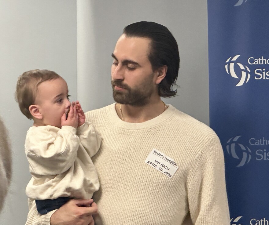 Alex Tuch holding his son, Teller.