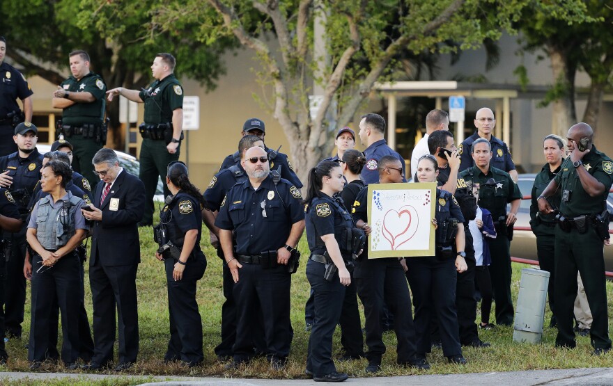 Police stand watch as students returned to class for the first time since a former student opened fire with an assault weapon at Marjory Stoneman Douglas High School in Parkland, Fla., Wednesday, Feb. 28, 2018. 