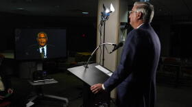 Due to COVID-19 precautions, the three gubernatorial candidates and the moderator were in separate rooms at WFYI studios in Indianapolis. Here, Republican Gov. Eric Holcomb watches Democrat Dr. Woody Myers speak.