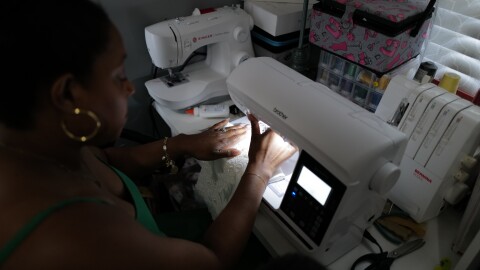 Heather Wilson sews an angel gown in her Virginia Beach home. Wilson’s nonprofit, Kennedy’s Angel Gowns, turns donated wedding dresses into burial gowns for babies.