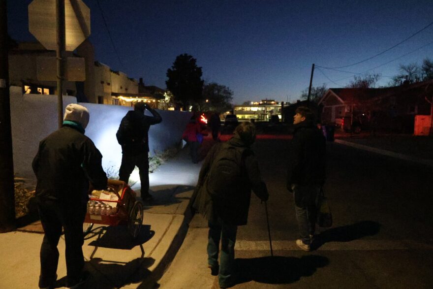 A small group of volunteers walks through alleys in downtown Albuquerque in search of unhoused people to survey on Jan. 28, 2025. The New Mexico Coalition to End Homelessness on Nov. 17, 2025 released the latest results of its “point in time” count detailing demographic and other information about the state’s unhoused population. (Patrick Lohmann /Source NM)