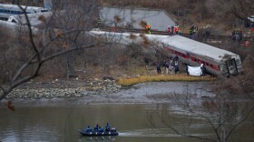 Search and rescue teams work at the scene of Sunday's passenger train crash in the Bronx. The train crash killed four people and injured dozens more.