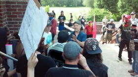 Local white supremacy sympatizer Karl Hand (center, in blue shirt) is confronted by protesters at a 2016 "White Lives Matter" rally in Buffalo. Police eventually had to separate the two movements.