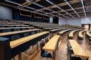 rows of seats and desks in a lecture hall