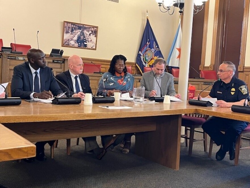 Syracuse Common Councilor Chol Majok, left, and his colleagues meet with Police Chief Joe Cecile, right, at a budget review session Apr. 29, 2024.