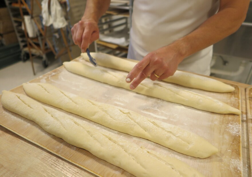 Francois Morin scores his baguettes before baking them. The traditional baguette receives five slits with a lame to control the bread’s expansion while baking.