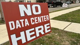 Signs opposing a data center north of Ashville, Ohio line the streets of that village.