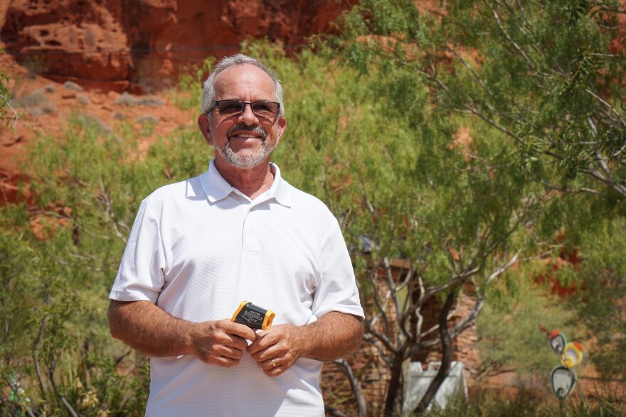 Washington County Water Conservancy District Conservation Manager Doug Bennett stands beside some shade-giving trees at the Red Hills Desert Garden in St. George, Aug. 20, 2026.