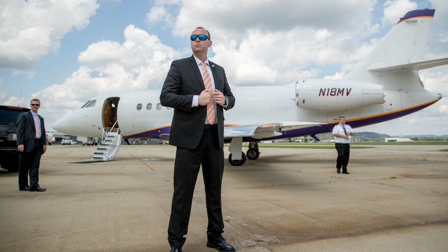 Members of the Secret Service stand guard outside a plane carrying Democratic presidential candidate Hillary Clinton in Cincinnati in August 2016.