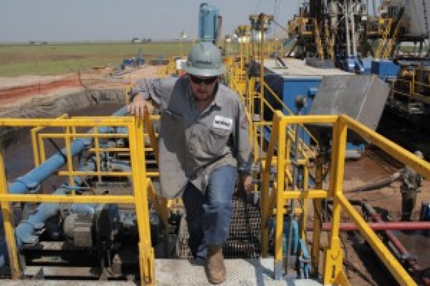 Toolpusher and rig manager Darrin Silcot walks the perimeter of a Triad Energy horizontal drilling operation near Alva, Okla. The company's CEO, Mike McDonald, says the tax incentive for horizontal drilling has led to more drilling at his company and othe