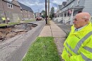 Wilkes-Barre Mayor George Brown stands near a sinkhole that opened Wednesday afternoon, June 25, on Horton Street in the city. Repairs could take several days, Brown said, and streets around the hole will be closed to all but residents in the meanwhile.