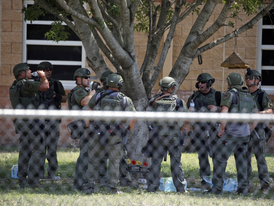 Law enforcement personnel stand outside Robb Elementary School following a shooting on Tuesday in Uvalde, Texas.