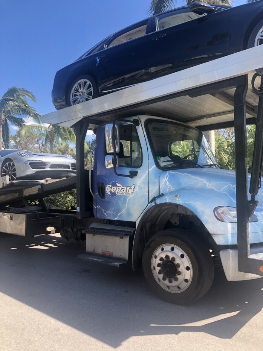 Tow truck picks ups flooded cars in Bonita Springs