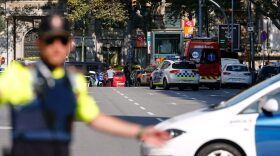 A policeman stand as he blocks the street to a cordoned-off area after a van plowed into a crowd, injuring several persons on the Rambla in Barcelona on Aug. 17, 2017. (Pau Barrena/AFP/Getty Images)