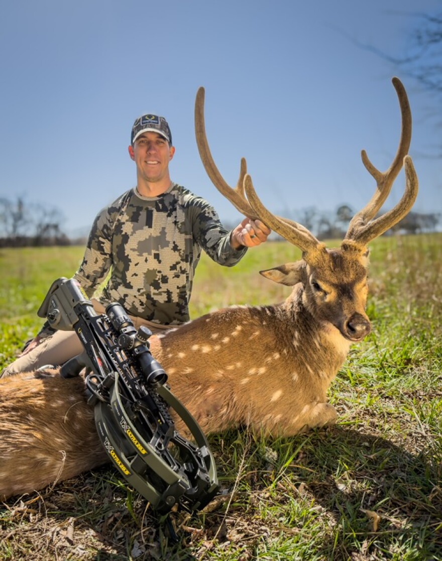 Brian Flaherty with an axis buck taken down with a Tenpoint crossbow at Choctaw Hunting Lodge in southeast Oklahoma.