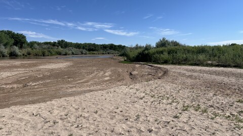 The Rio Grande in Albuquerque could begin running dry in stretches within the next week or two. Here, a thin stream of water flows through the river bed on May 14, 2026.