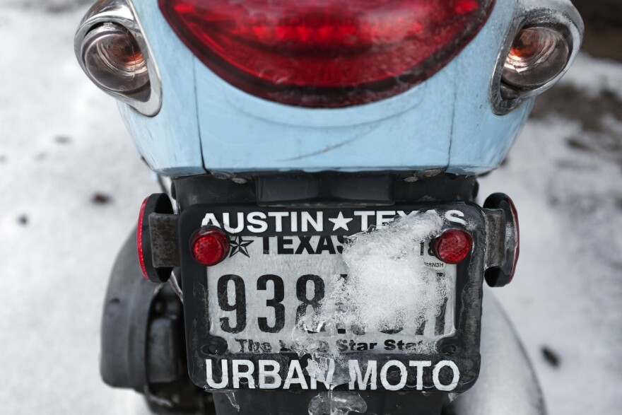 Snow and ice gather on a license plate Thursday, Feb. 18, 2021, in Austin, Texas. Temperatures dropped into the single digits as snow shut down air travel and grocery stores.(AP Photo/Ashley Landis)