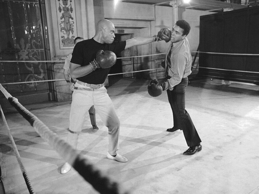 Muhammad Ali (right) takes on James Earl Jones in the ring. When this photo was captured in 1969, Jones was making the film <em>The Great White Hope</em> and Ali dropped by to help drum up publicity.