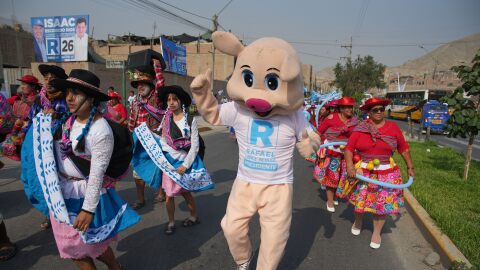 Supporters of a presidential candidate dance in the street
