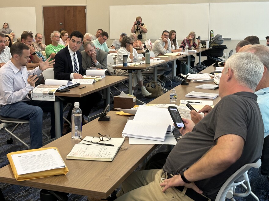 Jon Culp, right, whose family owns a home next to a proposed solar farm, describes for the Lehman Township Zoning Hearing Board the geography of the area. Culp is among residents who have protested the solar project. His lawyer, John McShea, sits next to him wearing a suit. The zoning board denied Susquehanna Solar's application for a 46-acre solar project on Aug 19.