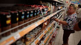 A woman choses sweets at a counter with imported food stuffs at a supermarket in downtown Moscow on Thursday, Aug. 7, 2014.The Russian government has banned all imports of meat, fish, milk and milk products and fruit and vegetables from the United States, the European Union, Australia, Canada and Norway, Prime Minister Dmitry Medvedev announced Thursday.
