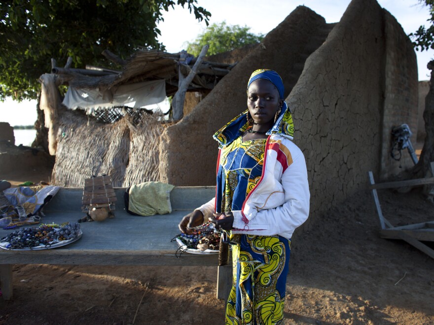 Kadija, a jewelry vendor, stands next to her stall in Djenne on Aug. 31. In previous years, the town had nearly 10,000 annual tourists. But since March, fewer than 20 tourists have come to Djenne, according to the local tourism board.