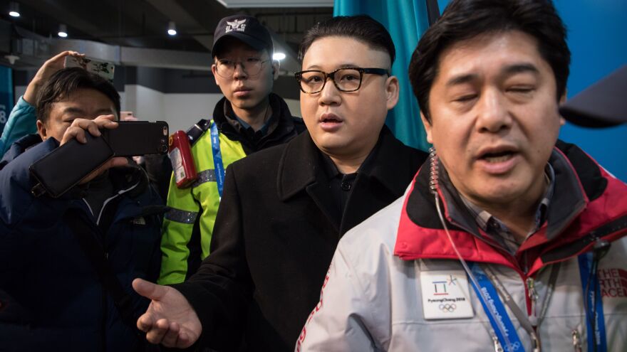 The faux Kim leaves the stands escorted by South Korean police and venue staff, now looking rather more nonplussed than his star turn in front of the cheerleaders.